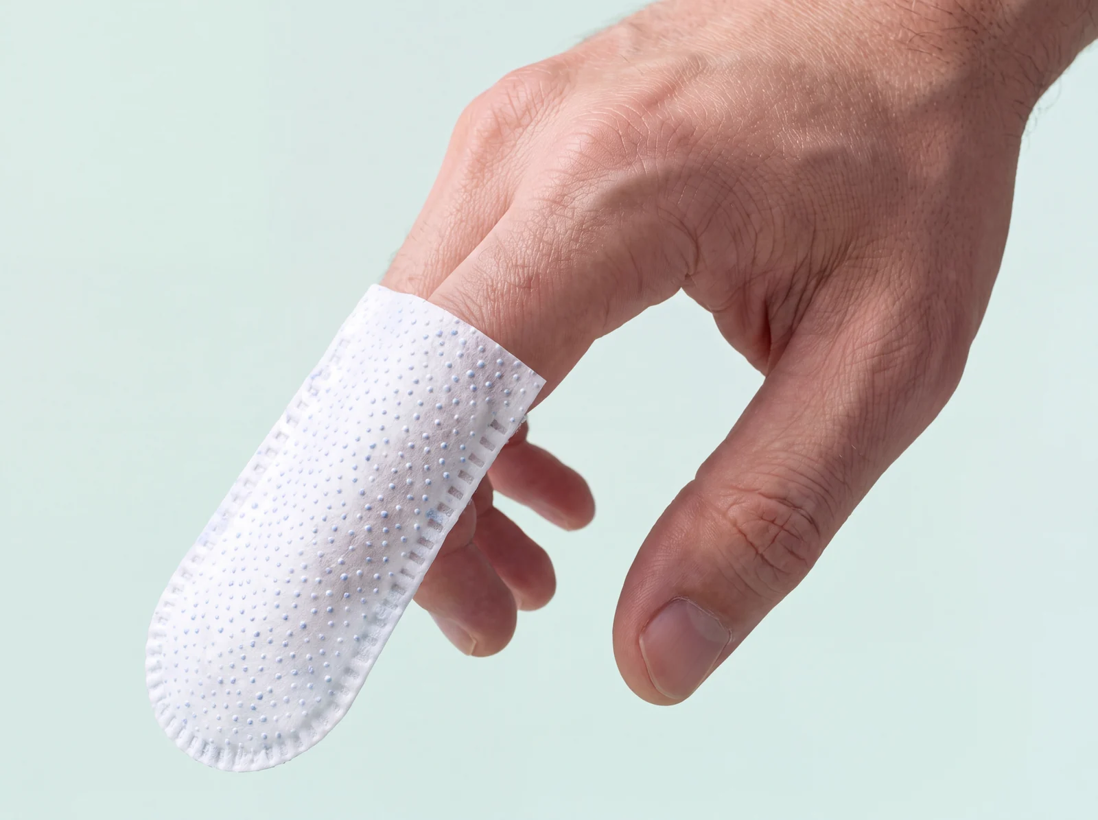 A Koofo finger wipe on an index finger, scrub side with fine dots