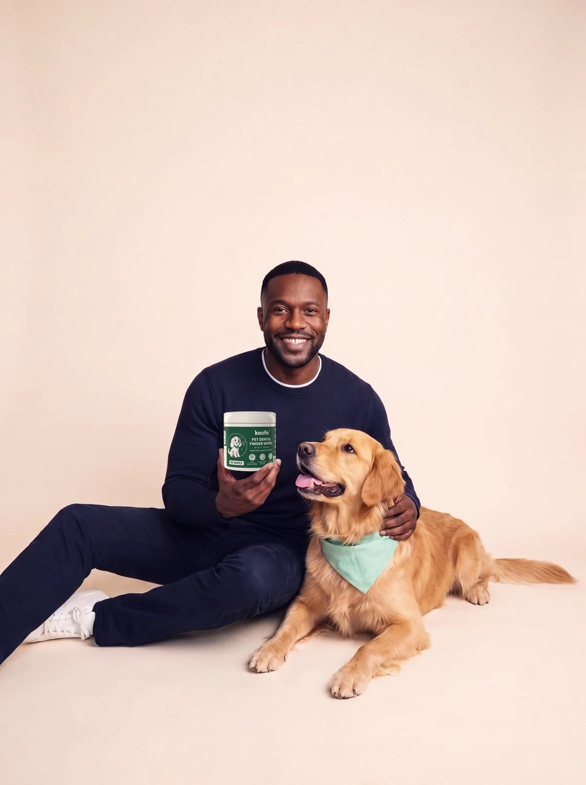 Daniel holding a can of Koofo Pet Dental Finger Wipes next to Sunny
